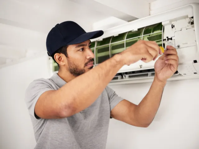 Local I Care Air Care technician handling an AC repair near Wesley Chapel