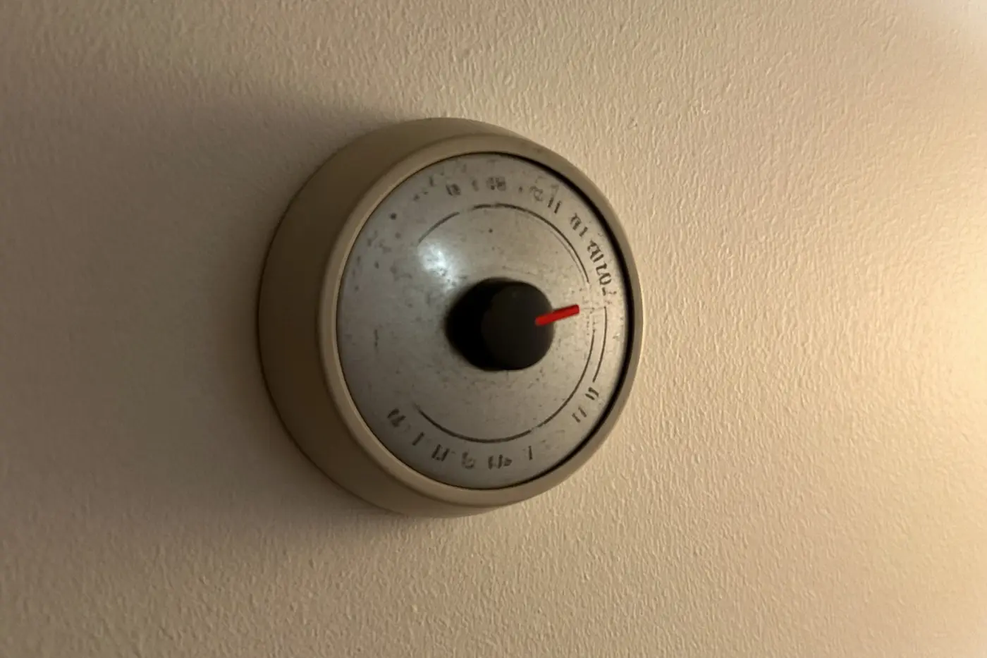 Round wall thermostat in a Wesley Chapel home, used to switch from AC to heat